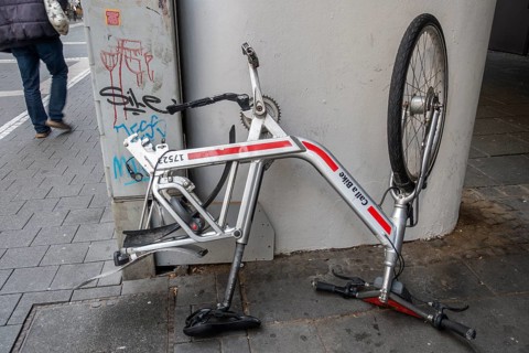 Bicycle standing on handlebars and saddle with dismounted rear wheel from Call a Bike of Deutsche Bahn