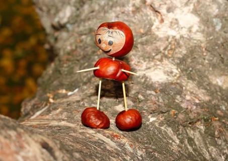 Cute chestnut figure on birch trunk