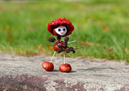 Chestnut figure with hat wearing black alder cones