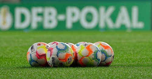 Adidas Derbystar match balls in front of perimeter advertising DFB Cup