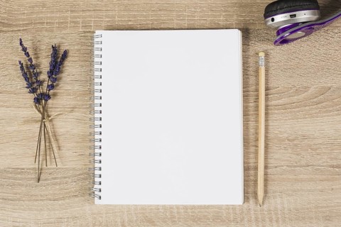 Blank spiral notebook pencil headphone lavender twigs wooden background