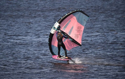 Young woman windsurfing Wingfoil at the North Sea