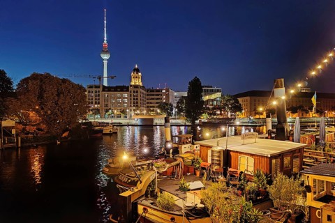 Historic harbour with museum ships and television tower in the blue hour