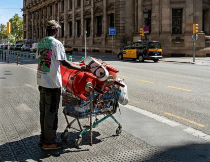 Man collects small metal in shopping trolley
