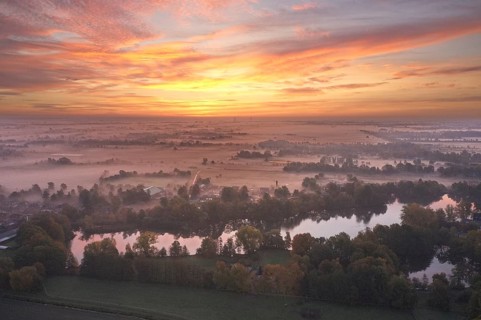 Aerial view of the landscape around Sandbraak Lake near Fuenfhausen in Hamburg's Kirchwerder district in autumnal morning atmosphere with light ground fog. In the background the nature reserve Kirchwe...