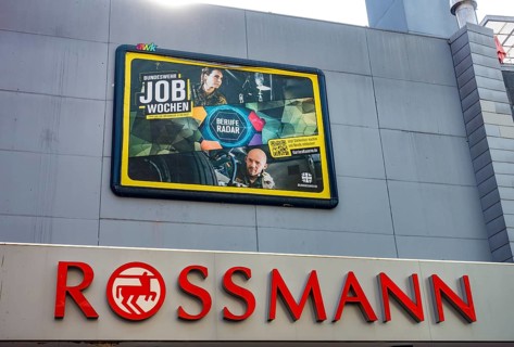 Large poster advertising the Bundeswehr on the wall of a Rossmann shop