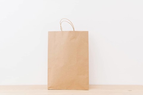 Brown shopping bag wooden surface