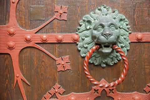 Fittings with lion's head and door knocker ring on the church door of St. Valentinus and Dionysius