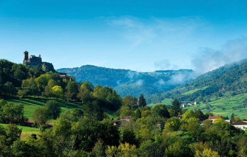 Saint-Ilpize castle perched on a volcanic peak above river Allier. Haute-Loire department. Auvergne-Rhone-Alpes. France