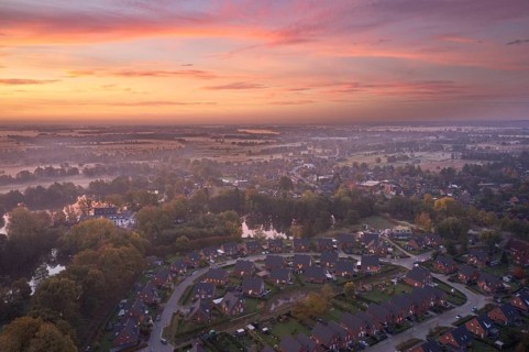 Aerial view of the landscape around Sandbraak Lake near Fuenfhausen in Hamburg's Kirchwerder district in autumnal morning atmosphere with light ground fog. In the foreground the residential area Fritz...