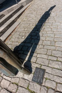 Foot of the pilgrim statue in front of the Protestant St. Jakob's Church with inset floor plate to the Way of St. James to Santiago de Compostella