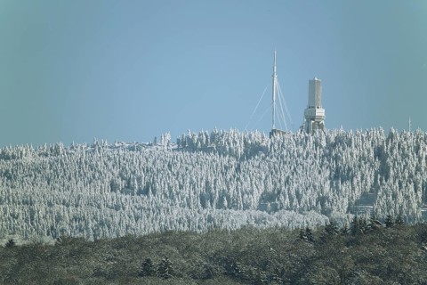 View of Grosser Feldberg with broadcasting tower in winter landscape