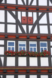 Idyllic house wall with shutters and flower decoration from the historic town hall