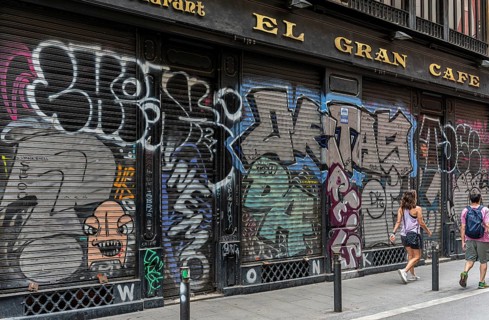 Graffiti on the blinds of vacant shops in the old town of Barcelona