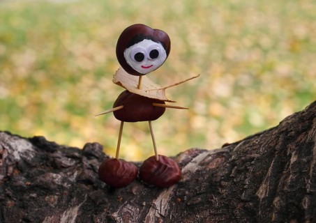Cute chestnut figure on birch trunk