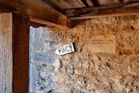 Sign WC at the historic town wall with covered battlements