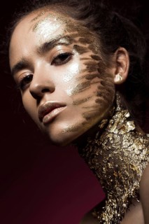 Beautyful girl with gold glitter on her face.Art image beauty face. Picture taken in the studio