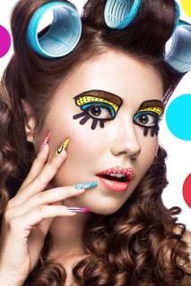 Photo of surprised young woman with professional comic pop art make-up and design manicure. Creative beauty style and nails. Photos shot in studio