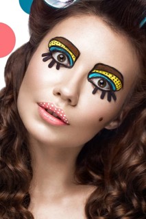 Photo of surprised young woman with professional comic pop art make-up and design manicure. Creative beauty style and nails. Photos shot in studio