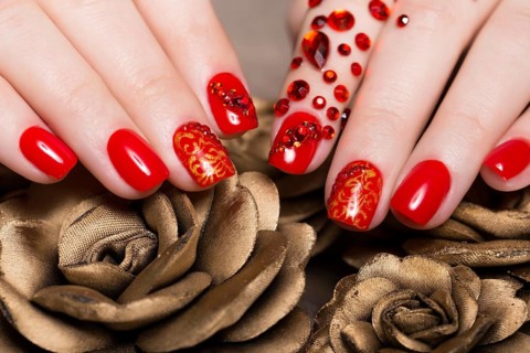 Shot beautiful manicure with rhinestones on female fingers. Nails design. Close-up. Picture taken in the studio