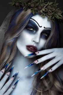 Portrait of a horrible scary Corpse Bride in wreath with dead flowers