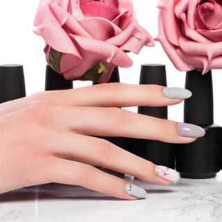 Black bottles of nail polish on a background of flowers. Manicure design