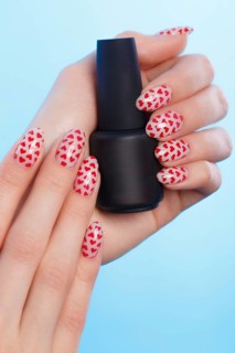 Black bottles of nail polish on a blue background. Manicure design