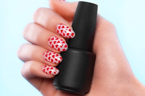 Black bottles of nail polish on a blue background. Manicure design