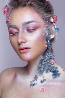 Beautiful girl in the image of a sweet fairy with art make up. Creative look. Photo taken in the studio
