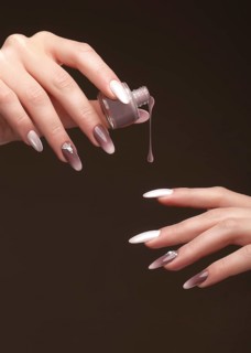Beautiful classic manicure on female hand with nail polish. Close-up. Picture taken in the studio