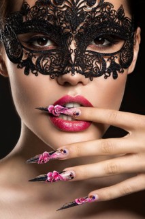 Beautiful girl with long nails and sensual lips. Portrait shot in the studio on a black background.Beauty face