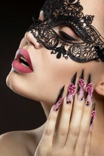 Beautiful girl with long nails and sensual lips. Portrait shot in the studio on a black background.Beauty face