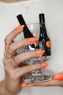 Bright neon manicure on female hands with accessories. Nail design. Beauty hands