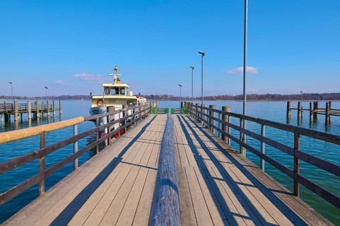Lake Ciemsee with pier and excursion boat