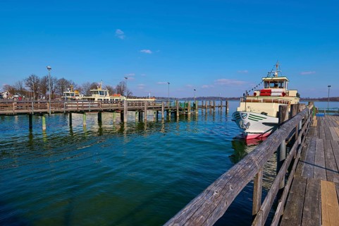 Lake Ciemsee with pier and excursion boat
