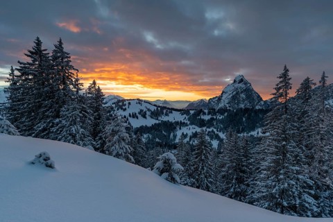 Sunrise in the Mythen region with the Grossen Mythen rising out of the snowy landscape