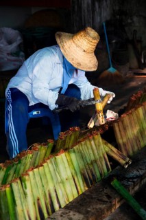 A woman in a straw hat preparing Sticky Rice