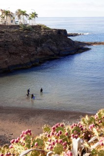 Divers Sport divers with scuba go from land into water in narrow sheltered bay