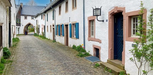 Historic alley with cobblestones in the background Gatehouse archway into old village Burgdorf 13th century Burgbering from today destroyed Kronenburg