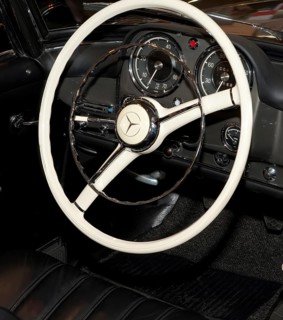 Steering wheel instrument panel with analogue round instruments of historic sports car classic car Mercedes Benz 190 SL