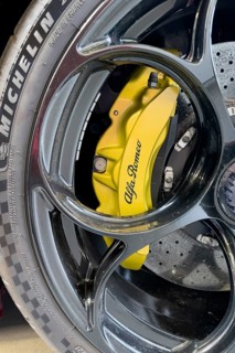 Detail of yellow brake caliper of limited edition 500 pieces Italian sports car Alfa Romeo Giulia GTAm