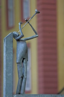 Modern sculpture as trumpeter made of metal