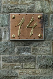 House number 14 made of brass with copper and rivets
