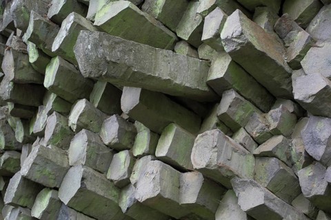 Basalt stone wall with basalt prisms