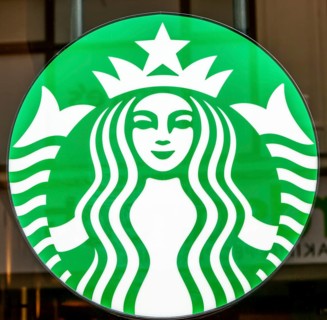 Close up of Starbucks twin-tailed siren brand logo sign