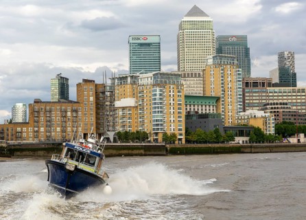 Metropolitan police speedboat motor launch travelling at high speed