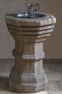 Historic 16th century baptismal font with baptismal font
