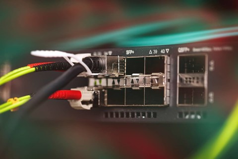 Fibre optic cables plug into a Fibre Channel Switch