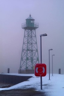 Lighthouse at the mouth of the river Geese in Bremerhaven in the fog