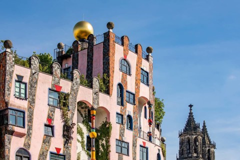Facade of the architectural work of art Green Citadel and Magdeburg Cathedral